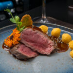 Grilled beef fillet, green peppercorn sauce and potato noisettes