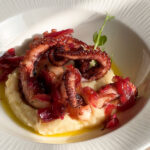 Double-cooked octopus tentacles, cream of broad beans, sautéed wild chicory and caramelized onion