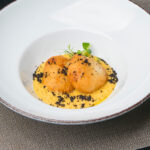 Cod nuggets in tempura, rosemary chickpea cream and dried black olives
